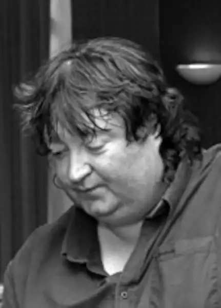Monochrome photograph of Brett Evans in half profile, looking down