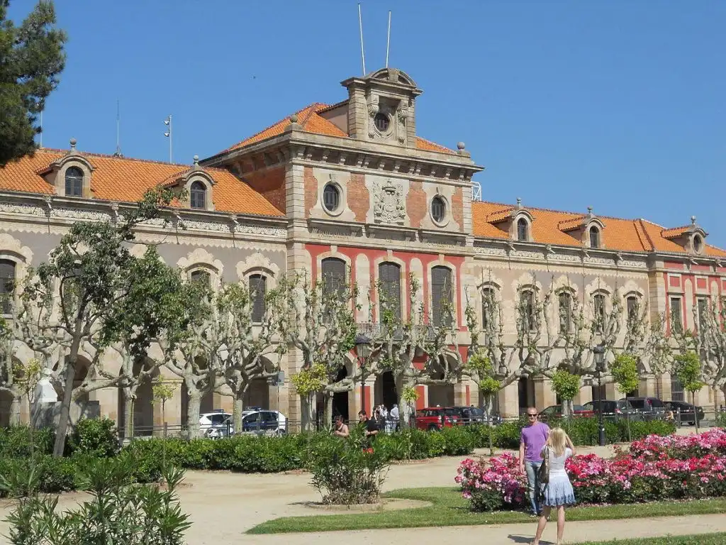 Parliament of Catalonia on summer day with young couple in foreground